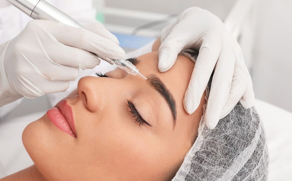 Young woman undergoing procedure of permanent eyebrow makeup in