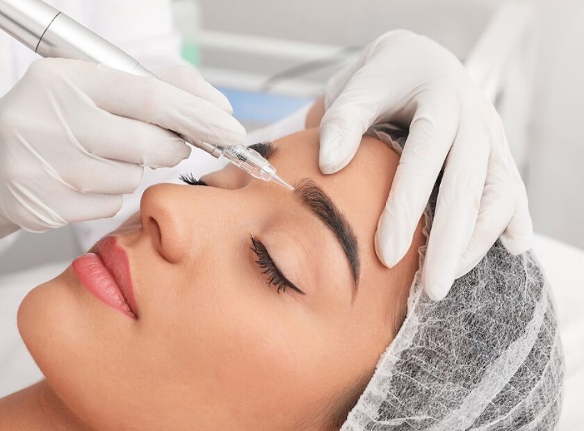 Young woman undergoing procedure of permanent eyebrow makeup in